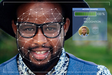 portrait of black men in stylish suits and black hat with glasses in a summer park. African-Americans handsome model hispanic businessman fresh snow-white smile, concept face id