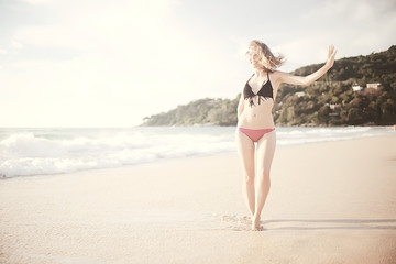 happy girl beach sea / girl in summer on the beach freedom wind wet hair, concept of summer vacation young beautiful girl