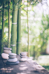 Background with bamboo and stones on an old wooden table. Japanese style. Simplicity, Zen, relax, calm and peaceful mood. Copy space