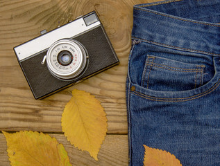 warm and romantic autumn - jeans, old retro camera, leaves