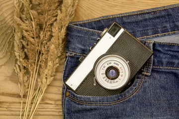 warm and romantic autumn - jeans, old retro camera, leaves