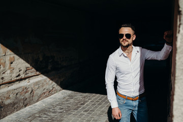 Happy young man posing outdoor, enjoying the sunny weather.