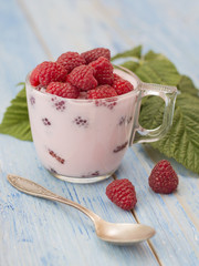 raspberry yogurt on a wooden background. 