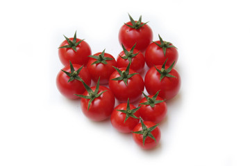 Small cherry tomatoes in shape of a heart isolated on white background

