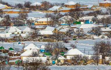 Winter village. Good New Year spirit. Houses in the snow. View from above.