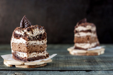 Tasty piece of chocolate cake on wooden table background