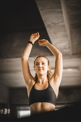 Fototapeta na wymiar Young long blond woman attractive fitness exercise workout in gym. Woman stretching the muscles and relaxing after exercise on machine treadmill at fitness gym club.