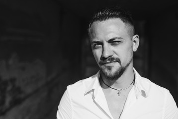 Portrait close up of handsome young businessman. Man dressed in white shirt. Black and white