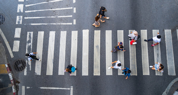 Aerial photo top view of people walk on street in the city over pedestrian crossing traffic road