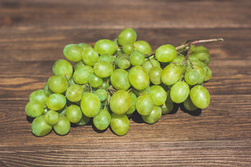 Grapes bunch on a old wooden background. Top view