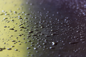 Water droplets on a grey plastic surface. Abstract background