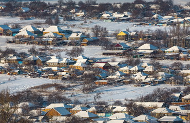 Winter village. Good New Year spirit. Houses in the snow. View from above.