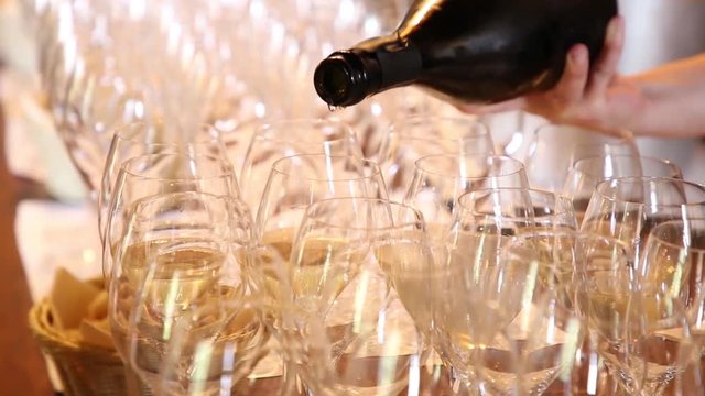 WOMAN POURING WHITE WINE
