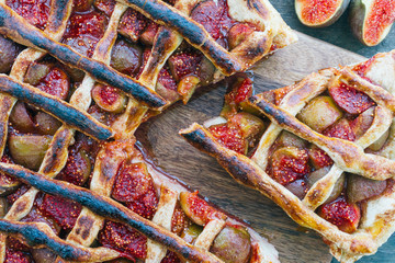 Autumn fig pie or tart with cinnamon on an old wooden table. Top view