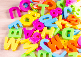 Fototapeta premium Plastic colored letters and numbers. Alphabet background