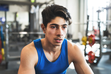 Fototapeta na wymiar A close up of a young man in crossfit gym, resting after an exercise.