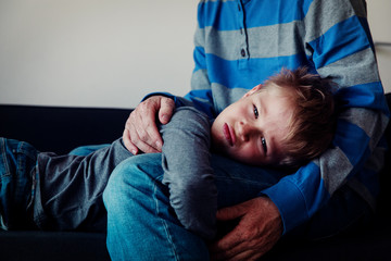 sad angry agressive child hugging dad at home, sorrow, pain, depression