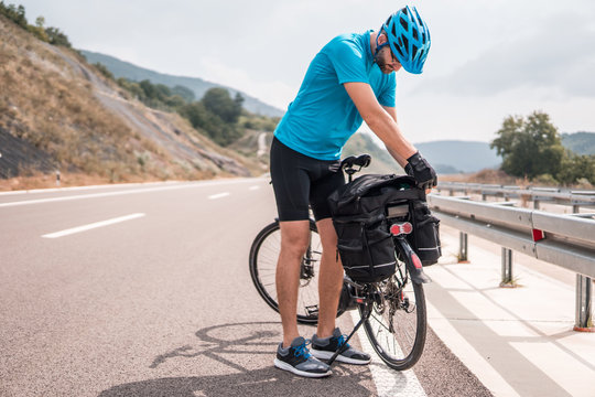Man riding a bike on an empty highway