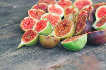 Fresh red figs background on an old wooden table. Top view. Close up