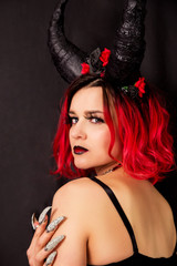 Red-haired model with horns. Halloween