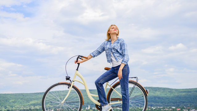 Woman rides bicycle sky background. Reasons to ride bike. Benefits of cycling every day. Keep fit shape easy with regular cycling. Girl ride cruiser bicycle. Health benefits of regular cycling