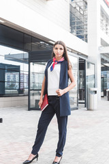 Beautiful Woman Going To Work With Coffee Walking Near Office Building. Portrait Of Successful Business Woman Holding Cup Of Hot Drink In Hand On Her Way To Work On City Street.