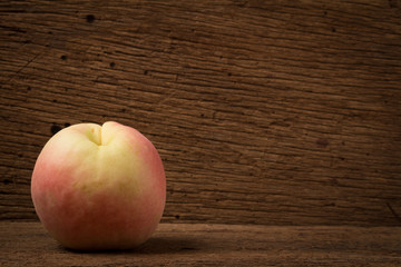 peach on old wood. sunlight