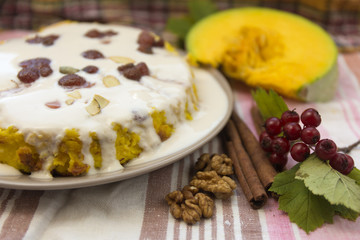 Pumpkin homemade cheesecake with white cream. Autumn still life. Thanksgiving day food.