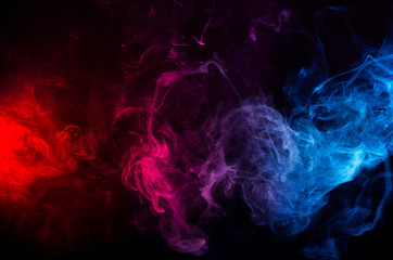 abstract shapes of mixed colors of blue and red smoke at dark background - 221448777