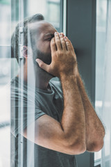 side view of depressed frustrated bearded man crying with hands on face - obrazy, fototapety, plakaty