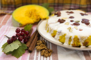 Pumpkin homemade cheesecake with white cream. Autumn still life. Thanksgiving day food.