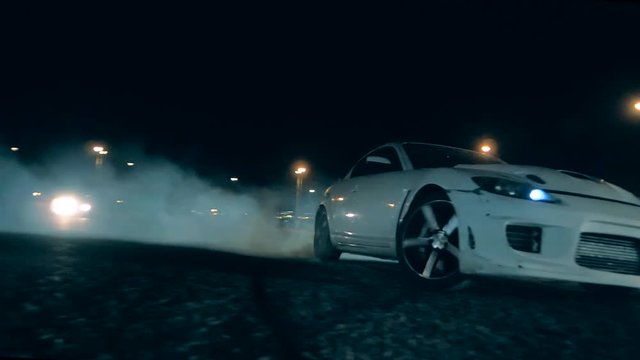 Sports car swiftly sweeps past the camera in drift