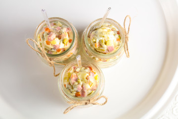 Russian salad in the glass can