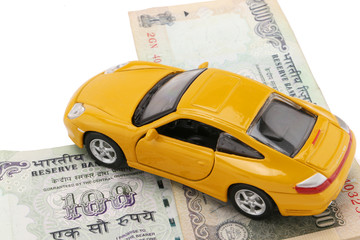 indian currency notes and toy car in the hands bank loan concept 