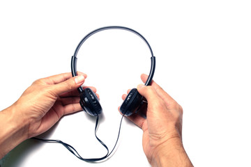 hands holding headset on white background isolated