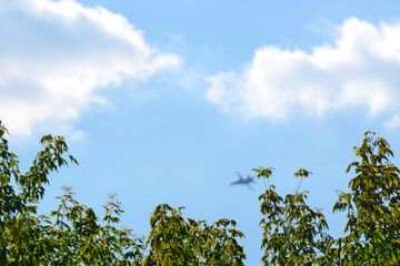 A blue sky with a high flying airplane.