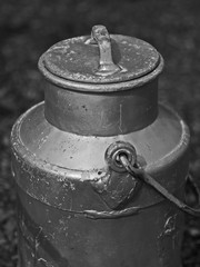 Antique silver aluminium raw milk can / container. Black and white image.