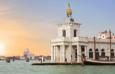 Fototapeta na wymiar Venice, Italy, Punta della Dogana center for contemporary art. This is a former Venice customs building. On the tower you can see the sculptures of Atlases, supporting the ball