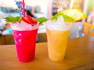 Closeup two cocktails and soft drinks Strawberry and pineapple on the table in restaurant.