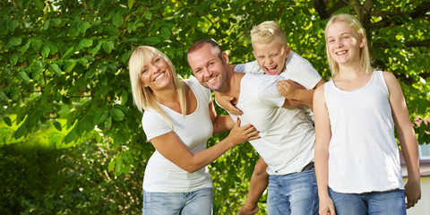 Parents giving piggyback ride to children