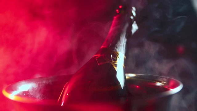 A bottle of expensive champagne is cooled in an ice bucket. Luxury. 4K. Food video