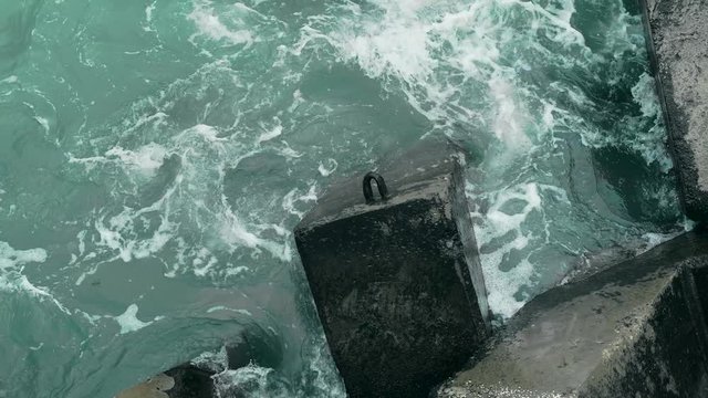 The sea surf ishes the cubes in the dock of the port city zone