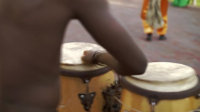 Ebony afro americans plays on ethnic bamboo drums