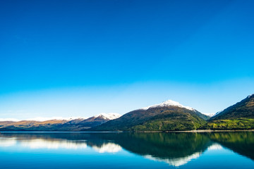Fototapeta na wymiar Stunning beautiful view beside lake Wanaka with alps mountain. Noon scenery with blue sky.