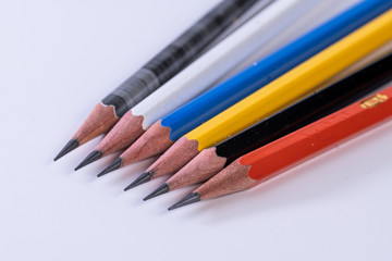 Several sharp new lead graphite pencils of various colors and patterns
