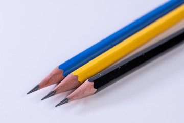 Several sharp new lead graphite pencils of various colors and patterns