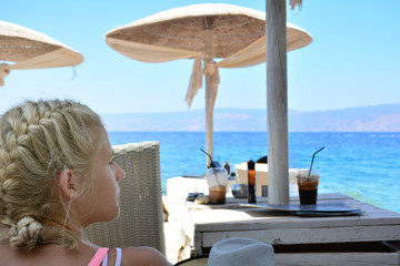 Young woman looking at the sea from beach resort