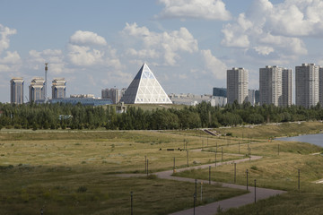 Shore of the Yesil River in Astana with the Palace of Peace and Reconciliation in the background