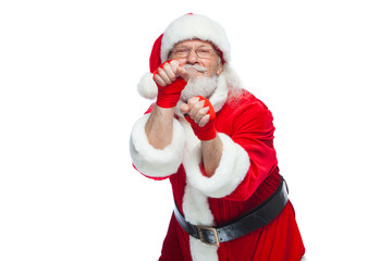 Christmas. Santa Claus with red bandages wound on his hands for boxing imitates kicks. Kickboxing, karate, boxing. Isolated on white background.