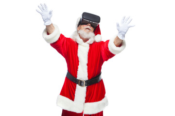 Christmas. Santa Claus in black virtual reality glasses makes gestures with his hands. Surprise, emotion. New technology. Isolated on white background.